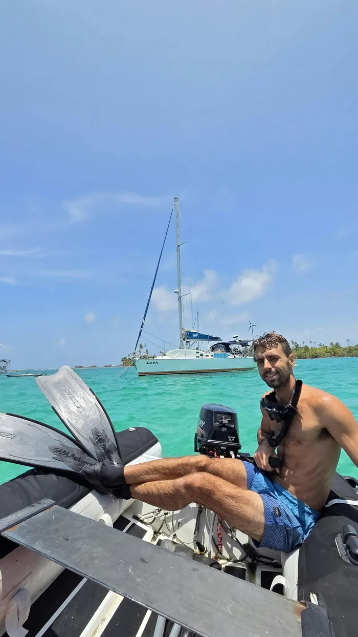 Heading out on the dinghy with the sailboat behind