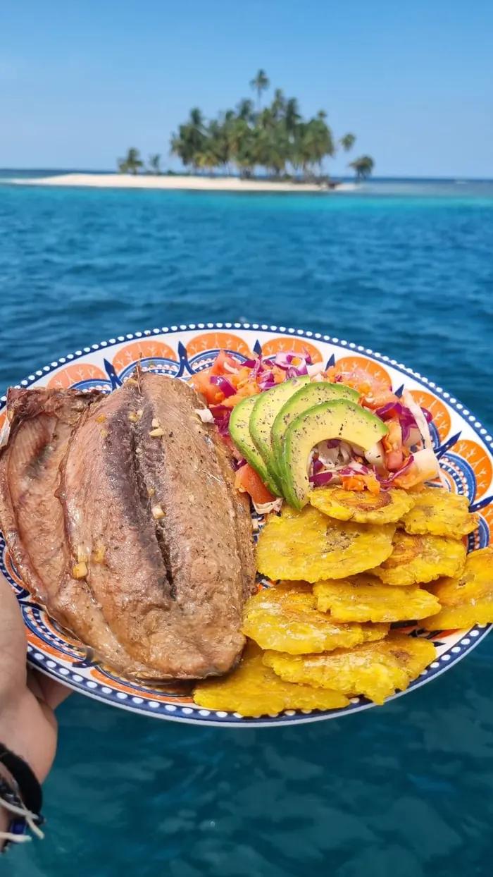 Fresh fish with patacones and avocado