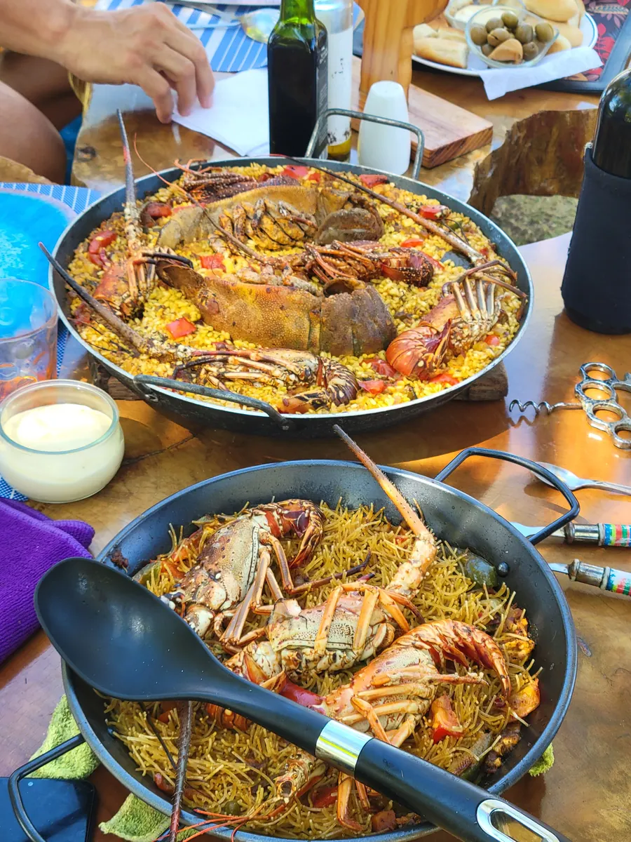 Homemade lobster paella served on board