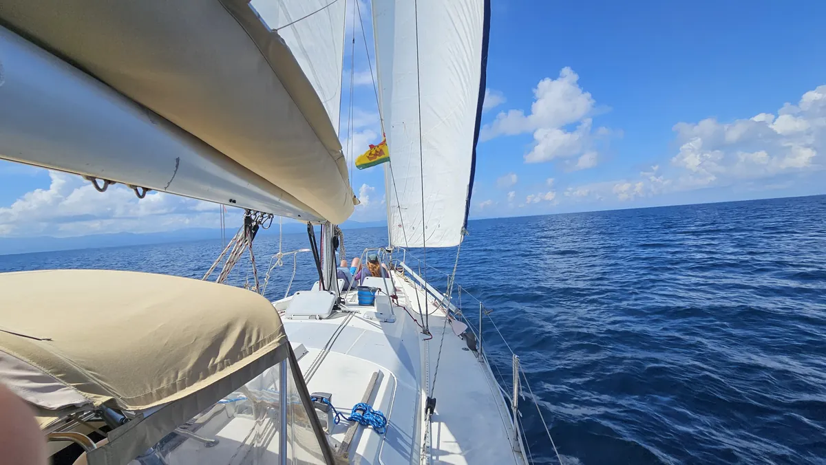 Sailing on a private sailboat with full sails on the open sea