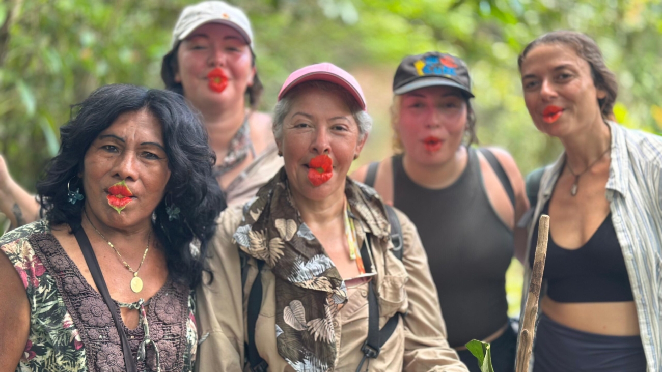 Group of women preparing for a jungle hike in Panama, with traditional face paint and walking sticks