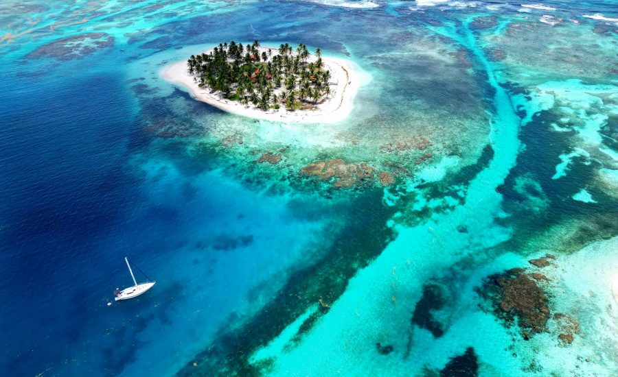 Aerial view of remote island and sailing catamaran in San Blas archipelago